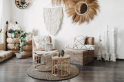 Bloomingville Oumou Wall Art in a cozy natural decor living room with woven furniture and plants.