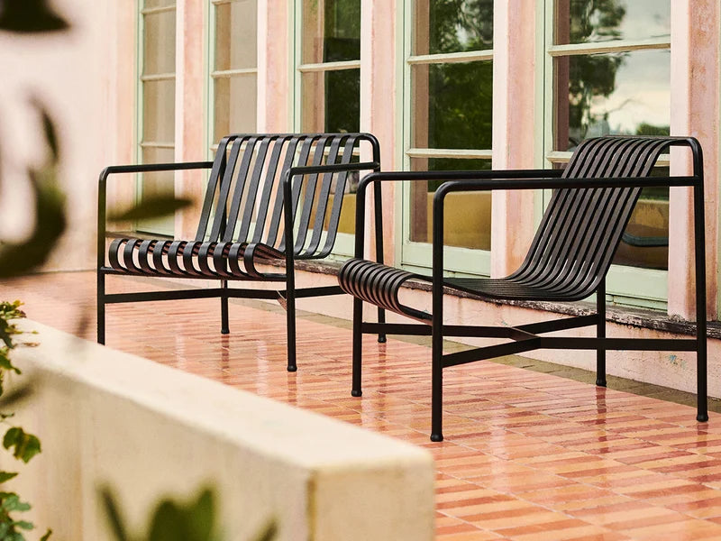 HAY Palissade Low Lounge Chair Olive styled in a serene outdoor setting with a modern design.